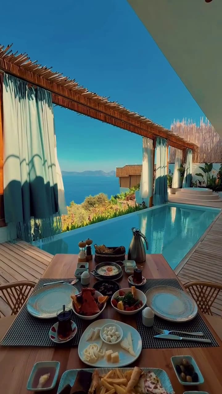 Orkide: türkisches Frühstück am Kopf des langen Pools, Meer und Schilfpergola.